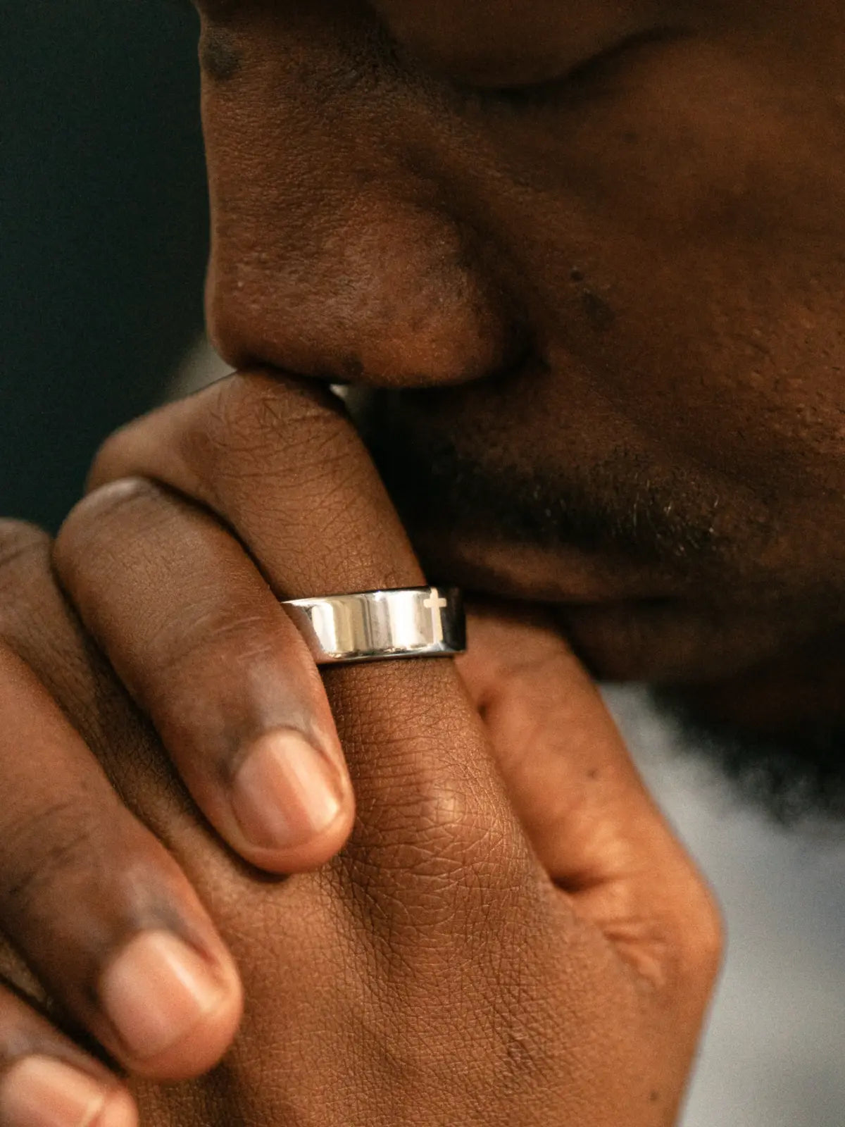 A person wearing Elah Ring with hands folded in prayer.